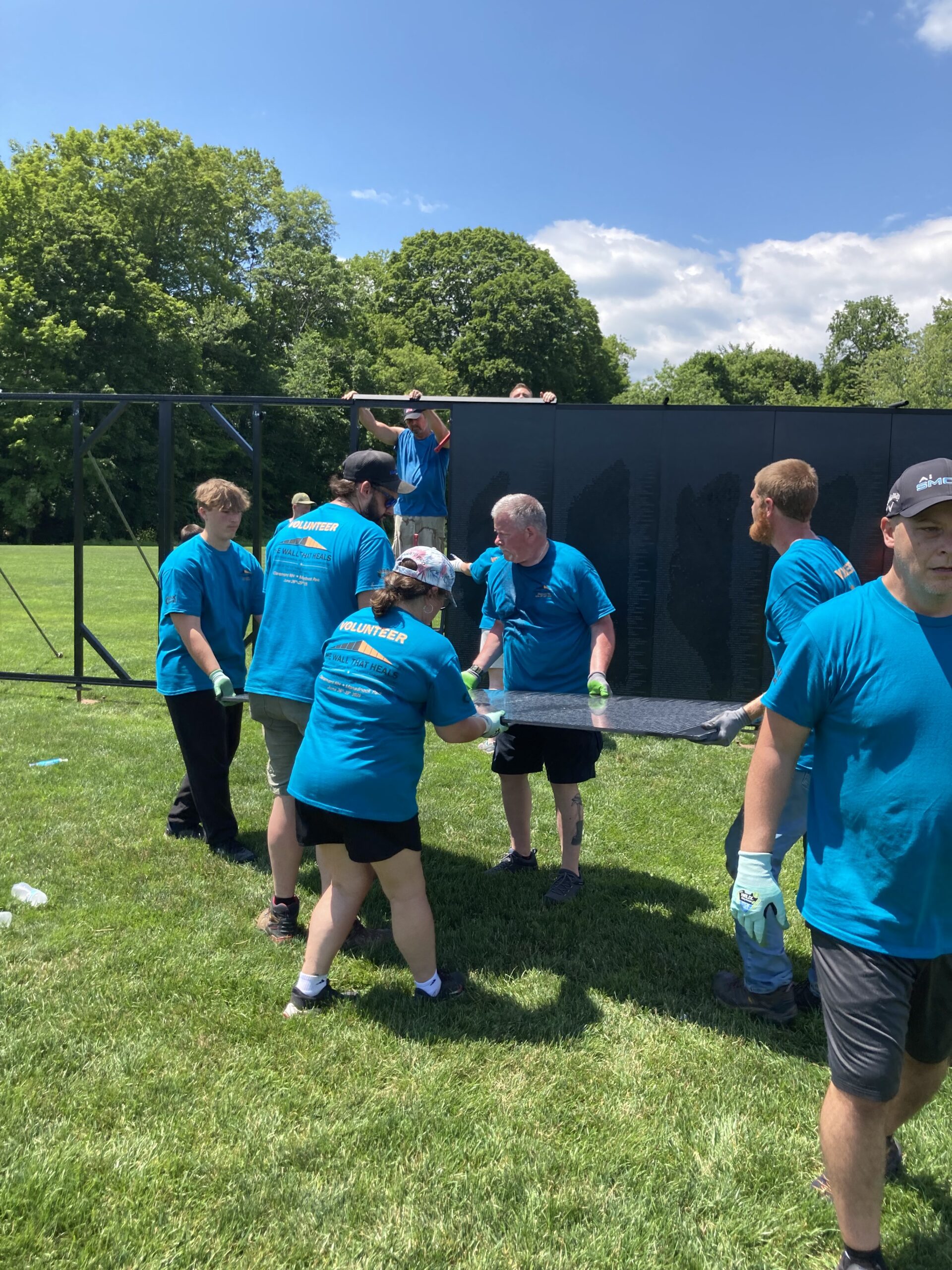 Volunteers follow strict guidelines to assemble the wall panels with respect.